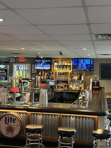 The bar at Stockley Tavern — draft taps, stools and the flat screens